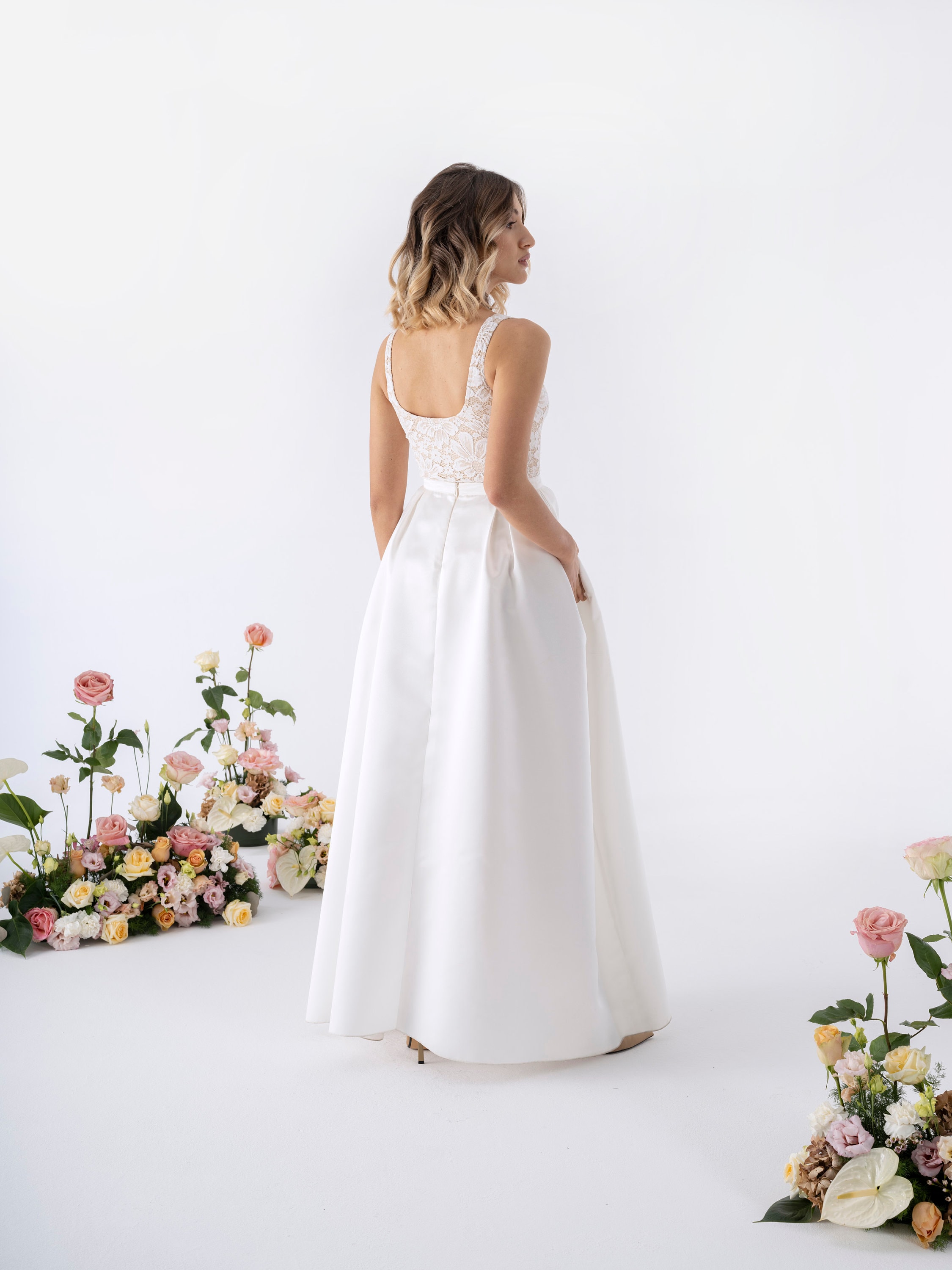 Lace bodysuit with open back and bridal satin skirt with pockets