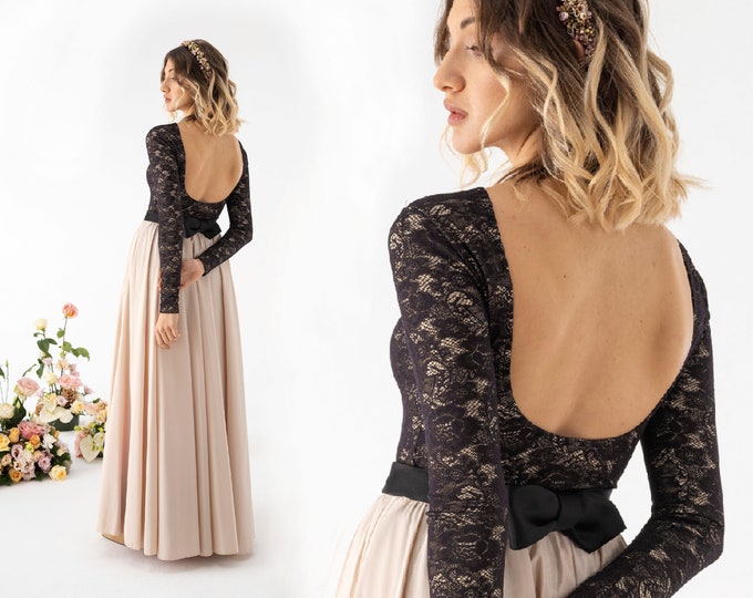 Black wedding dress composed by a lace bodysuit and a blush satin skirt