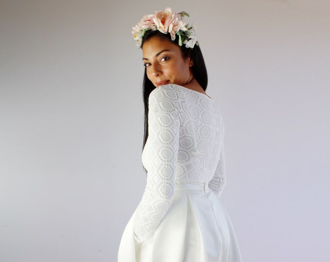 Simple two pieces wedding dress composed by a lace bridal bodysuit with long sleeves and a satin skirt with pockets