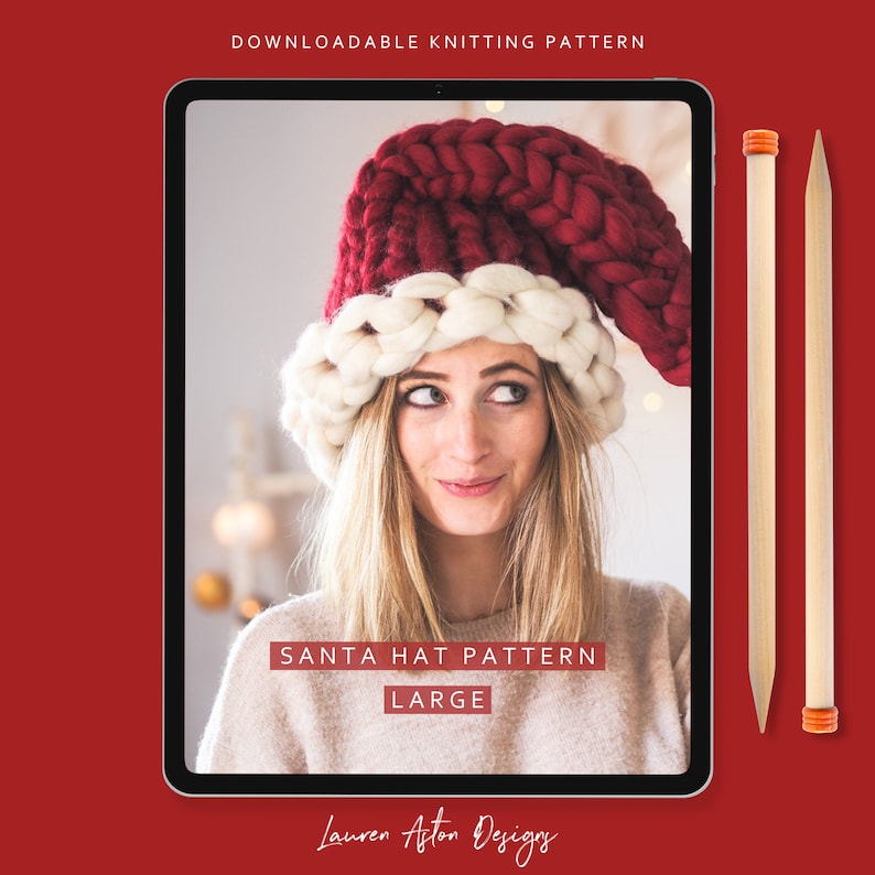 May include: A digital tablet displaying a knitting pattern for a large Santa hat. The pattern is titled "Santa Hat Pattern Large" and is by "Lauren Aston Designs". The image shows a woman wearing the hat, which is red and white.