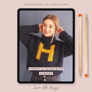 May include: A digital tablet displaying a knitting pattern for a blue sweater with a yellow "H" on the front. The text on the screen reads "HARRY'S FAVOURITE JUMPER" and "Lauren Aston Designs".