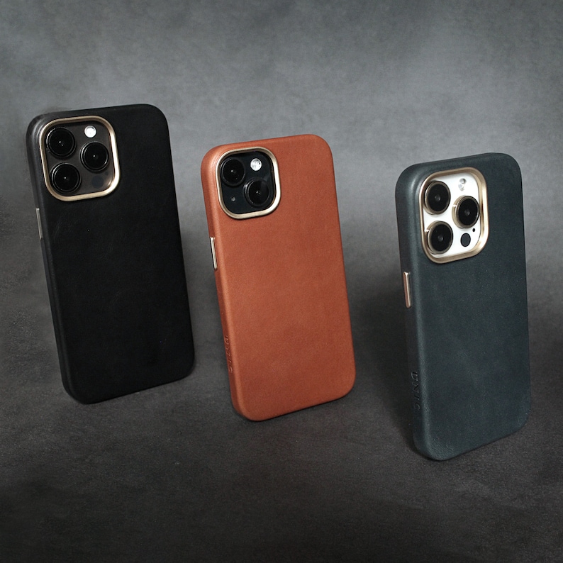 May include: Three different phone cases, one black, one brown, and one dark blue. Each case has a camera lens cutout and a textured surface.