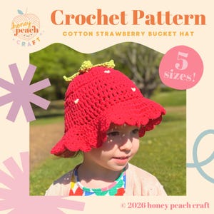 May include: A red crochet strawberry bucket hat with a green stem and white seeds. The hat is worn by a child. The image includes the text "Crochet Pattern" and "Cotton Strawberry Bucket Hat". The hat is available in 5 sizes.