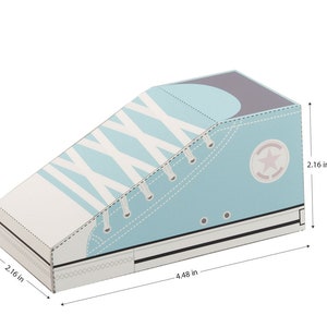 May include: A light blue shoe-shaped box with white laces and a white star on the side. The box measures 4.48 inches long, 2.16 inches wide, and 2.16 inches high.