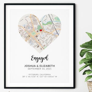 May include: Framed print featuring a heart-shaped map of Pittsburg, California, with a red heart marking a location. The word "Engaged" is written above the names Joshua & Elizabeth and the date September 10, 2021. Coordinates are also included.