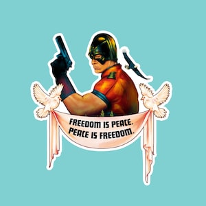May include: A sticker featuring a character in a helmet and costume, holding a gun. Two white doves and an eagle are also present. The text "FREEDOM IS PEACE. PEACE IS FREEDOM." is displayed on a banner.