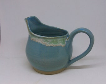 Small ceramic jug in turquoise blue with minty green rim,  thrown on pottery wheel, shiny glaze, milk jug, small cream jug
