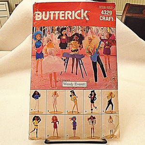 May include: Vintage Butterick pattern 4329 for craft projects. The cover features illustrations of dolls in various outfits, including musicians and dancers. The pattern is designed by Wendy Everett.