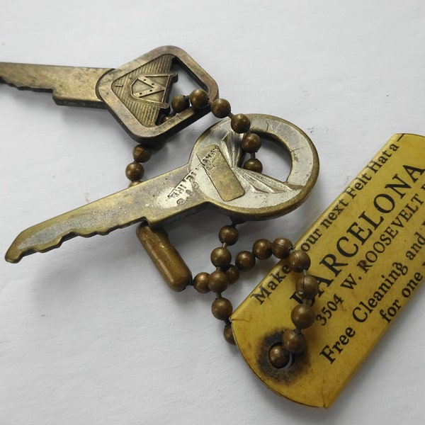 Two Vintage Ford Motor Company Automotive Keys and Barcelona Hat Advertisement