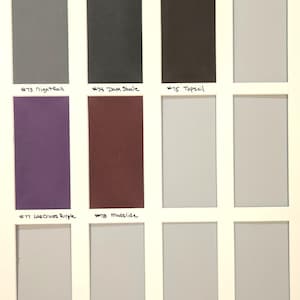 May include: A color swatch grid featuring twelve rectangular samples arranged in a four-by-three layout. Labeled colors include #73 Nightfall, #74 Dark Shale, #75 Topsoil, #77 Las Cruces Purple, and #78 Mudslide, alongside several unlabeled neutral gray tones.