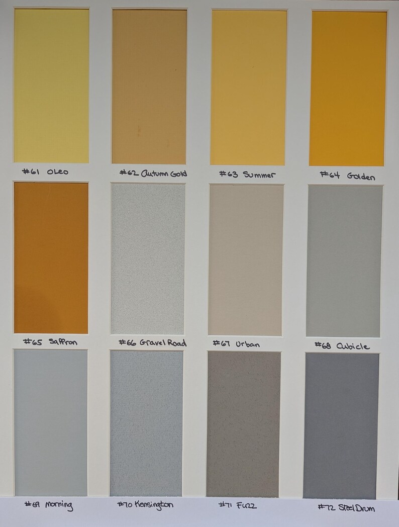 May include: A color swatch chart featuring twelve rectangular samples arranged in three rows. The colors include shades of yellow, gold, orange, beige, and various tones of gray. Each sample is labeled with a number and a name, such as #61 Oleo, #62 Autumn Gold, #63 Summer, #64 Golden, #65 Saffron, #66 Gravel Road, #67 Urban, #68 Cubicle, #69 Morning, #70 Kensington, #71 Fuzz, and #72 Steel Drum.