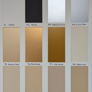 May include: A color swatch chart featuring twelve rectangular samples labeled #1 White, #2 Black, #3 Metallic Silver, #4 Silver Star, #5 Metallic Gold, #6 Rose Gold, #7 Old Gold, #8 Spice Ivory, #9 Fossil, #10 Sandpaper, #11 Putty, and #12 Toasty.
