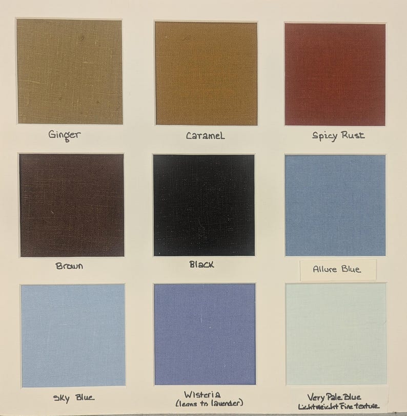 May include: A fabric colour swatch card featuring nine square samples in ginger, caramel, spicy rust, brown, black, allure blue, sky blue, wisteria, and very pale blue. Each square is labelled with its corresponding colour name in black ink.