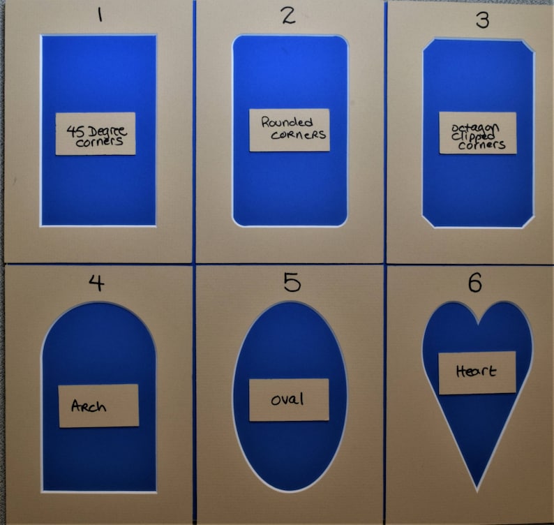 May include: Six beige rectangular picture mats with blue centers, numbered one through six. Each mat features a unique cutout shape: 45 degree corners, rounded corners, octagon clipped corners, arch, oval, and heart, with labels for each.