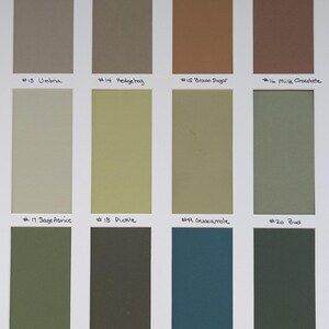 May include: A color swatch card featuring twelve rectangular samples arranged in three rows. The colors include shades of beige, brown, olive, green, and teal. Each swatch is labeled with a number and a name, such as #13 Umbria, #14 Hedgehog, #15 Brown Sugar, #16 Milk Chocolate, #17 Sage Advice, #18 Pickle, #19 Guacamole, #20 Bud, #21 Spinach, #22 Sierra Olive, #23 Real Teal, and #24 Forest Green.