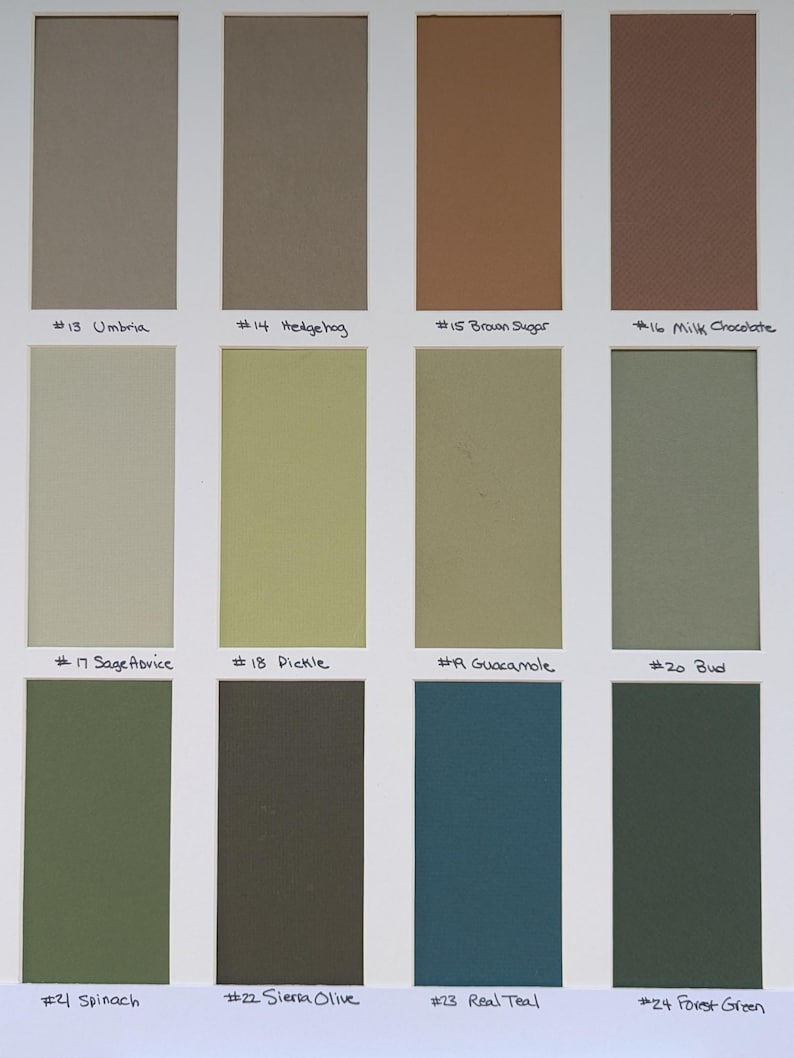 May include: A color swatch card featuring twelve rectangular samples arranged in three rows. The colors include shades of beige, brown, olive, green, and teal. Each swatch is labeled with a number and a name, such as #13 Umbria, #14 Hedgehog, #15 Brown Sugar, #16 Milk Chocolate, #17 Sage Advice, #18 Pickle, #19 Guacamole, #20 Bud, #21 Spinach, #22 Sierra Olive, #23 Real Teal, and #24 Forest Green.