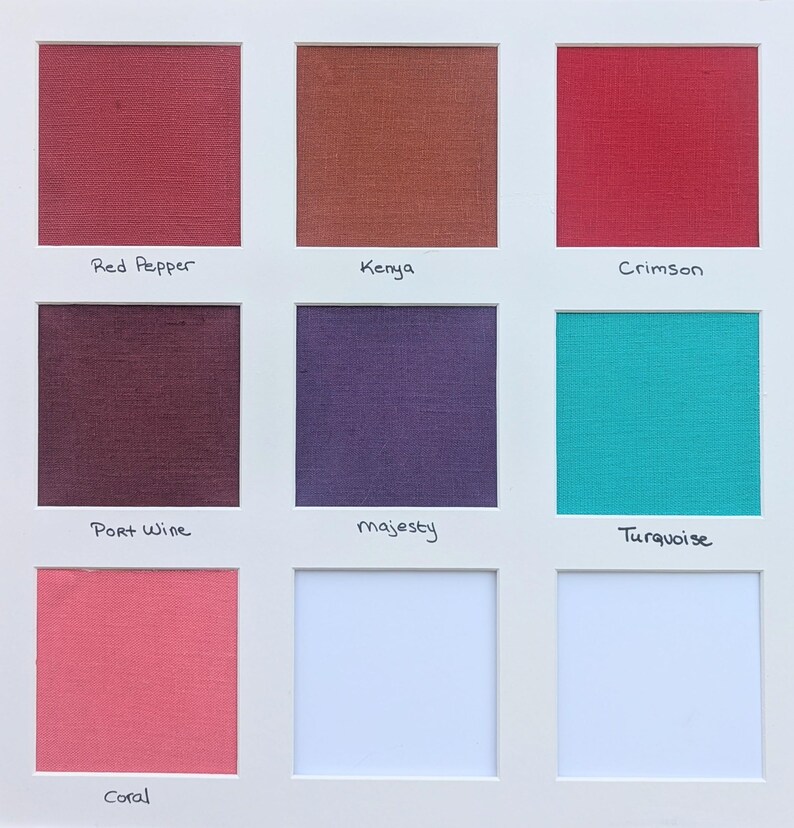 May include: A grid of eight fabric swatches mounted on a white board, labeled Red Pepper, Kenya, Crimson, Port Wine, majesty, Turquoise, and Coral. Each square displays a distinct solid color with a visible woven texture, arranged in a three-by-three layout.