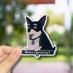 May include: A sticker featuring a cartoon dog with black and white fur, a green collar, and a tag. The sticker has the text "Who's a good boy?" in white on a black background. The dog is smiling with its tongue out.