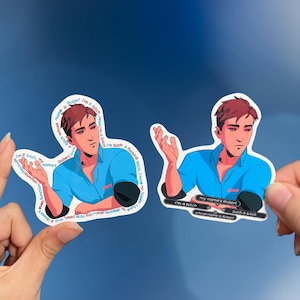 May include: Two stickers featuring a cartoon illustration of a person with brown hair and a blue shirt. The stickers have text that reads "I'm a bitch" and "my name's Robert". The stickers are held up against a blue background.