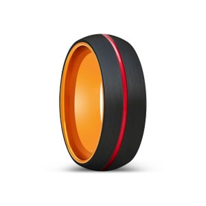 May include: A black and orange ring with a red stripe. The ring is made of tungsten carbide and has a brushed finish.