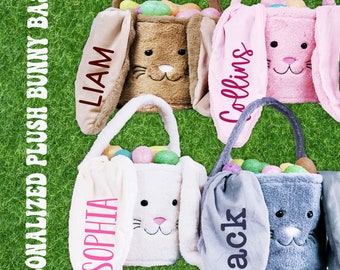 May include: Four plush bunny Easter baskets in brown, pink, white, and gray. Each basket has a personalized name on the side: Liam, Collins, Sophia, and Jack. The baskets are filled with colorful plastic Easter eggs.
