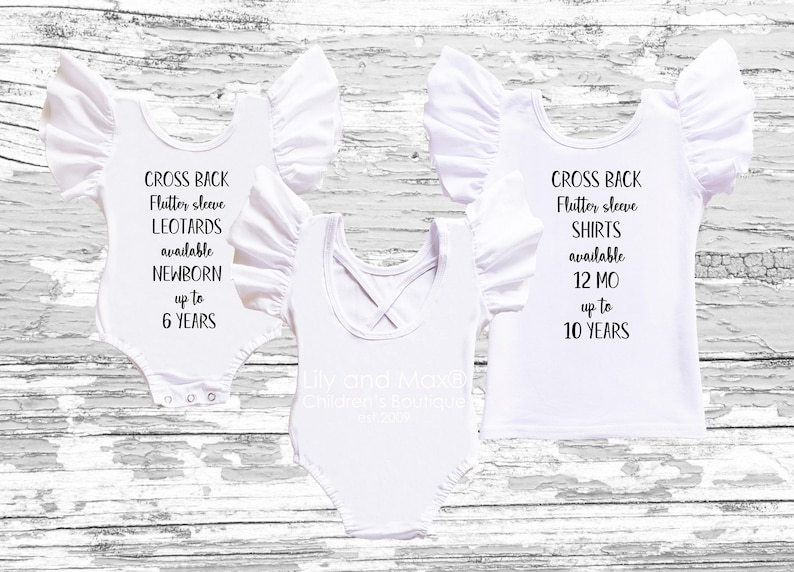 Three white children's garments displayed on a wood background, showcasing cross-back flutter-sleeve leotards and shirts with overlaid text describing available sizes.