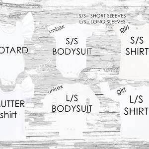A display of six different white children's garment styles labeled Leotard, Flutter shirt, S/S bodysuit, L/S bodysuit, S/S shirt, and L/S shirt against a white wood background.