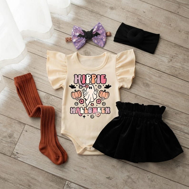 Cozy autumn flat lay showing the complete hippie ghost Halloween velvet skirt set for baby girls with bodysuit, skirt, tights, and headbands.