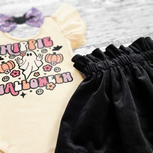 Close-up of the ultra-soft black velvet skirt waistband and the detailed retro ghost graphic on the bodysuit.