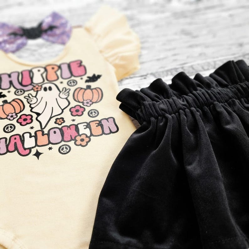 Close-up of the ultra-soft black velvet skirt waistband and the detailed retro ghost graphic on the bodysuit.