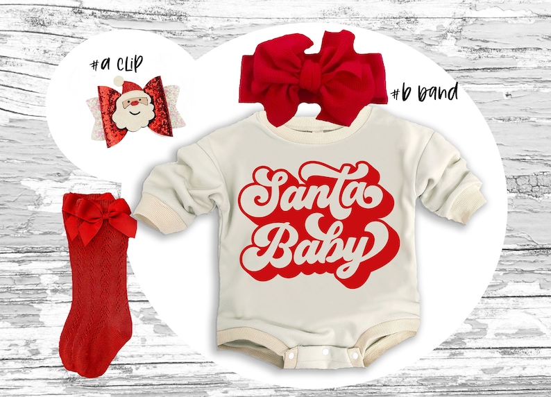 May include: A festive holiday ensemble featuring a cream-colored onesie with the text "Santa Baby" in red, a red bow headband, a red bow hair clip with a Santa face, and red knee-high socks with bows. Perfect for Christmas.