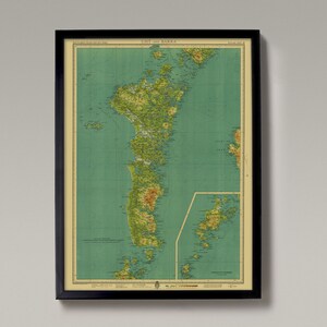 May include: A vintage map of the island of Uist and Barra in Scotland. The map is printed on a light green background with brown and green lines and text. The map shows the coastline, rivers, and mountains of the island. The map is framed in a black frame.