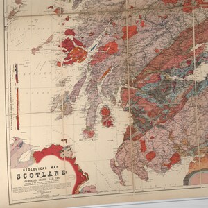May include: A vintage geological map of Scotland, featuring a detailed color-coded key and a title that reads "Geological Map of Scotland, Archibald Geikie, LL.D., F.R.S."