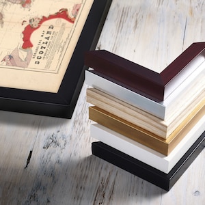 May include: A stack of different colored picture frames, including black, white, gold, wood, and burgundy. The frames are all in the same style and size, and they are arranged in a pyramid shape.