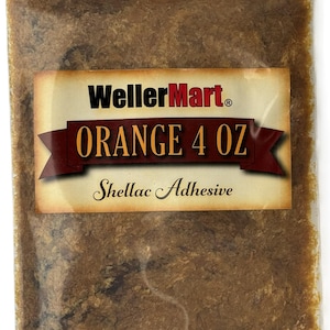 May include: A clear plastic bag containing 4 ounces of orange shellac adhesive. The bag has a label that reads "WellerMart" and "Orange 4 oz Shellac Adhesive".