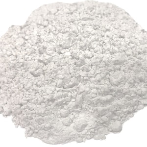May include: A close-up of a pile of white powder. The powder is fine and has a slightly grainy texture.
