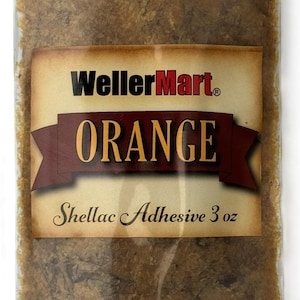May include: A clear plastic bag filled with orange shellac flakes. The bag has a label that reads "WellerMart® ORANGE Shellac Adhesive 3 oz".