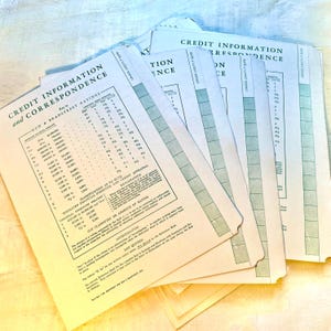 May include: A collection of vintage credit information and correspondence documents. The papers have a light green and white color scheme, with text and tables. The documents include the text "Credit Information and Correspondence" and "Dun & Bradstreet Ratings."