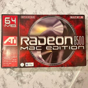 May include: A red and black box for a Radeon 8500 Mac Edition graphics card. The box features the ATI logo, the text "64 MB", and the words "Radeon 8500 MAC EDITION". The box also includes technical specifications and the Mac logo.