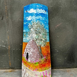 May include: Hand-painted tile featuring a whitewashed stone house with a green tree, blue sky with white clouds, and a path with pink flowers. The tile is signed "L. Vesuviano".