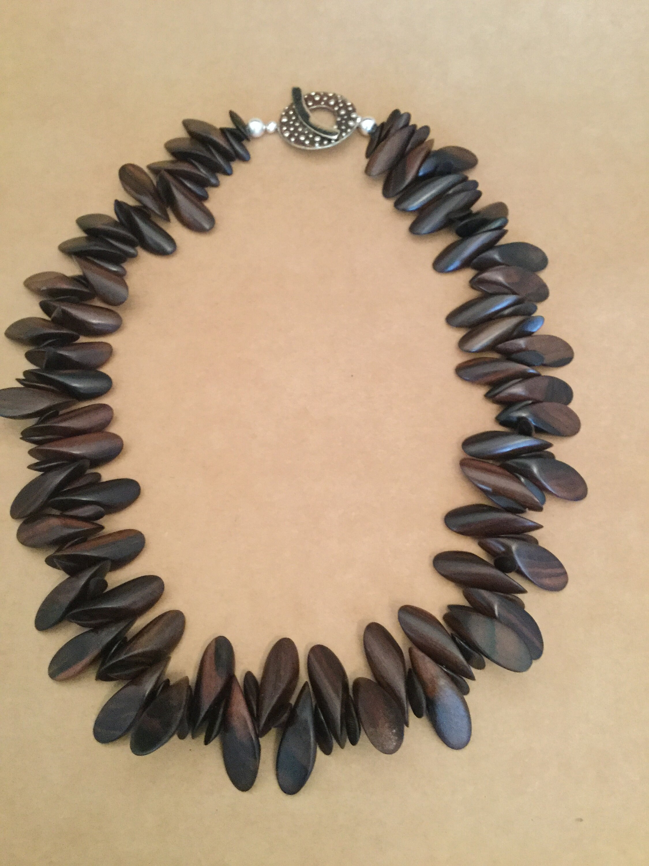 Finished wood necklace with Sterling Silver clasp.