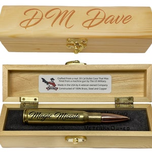 May include: A wooden box with a brass latch, containing a 50 calibre bullet case that has been engraved with the words "Magic Missile". The box is made of 100% brass, steel, and copper and is crafted from a real .50 calibre bullet case that was fired from a machine gun by the US military. The box is also engraved with the words "DM Dave" and "Veteran Owned".