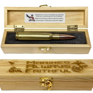 May include: A wooden box with a brass latch. The box is open and contains a 50 caliber bullet casing. The box is engraved with the words "Marines Always Faithful" and a Marine Corps emblem. The bullet casing is made from a real .50 caliber bullet case that was fired from a machine gun by the US Military. It is made in the USA by a veteran owned company and constructed of 100% brass, steel and copper.
