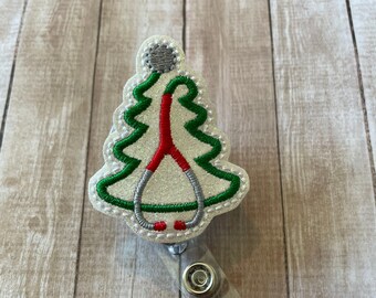 May include: White glitter Christmas tree-shaped badge holder with a red and silver stethoscope design.