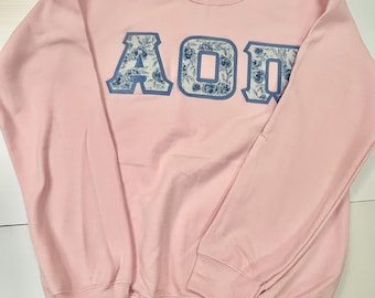 Sudadera rosa de la hermandad griega