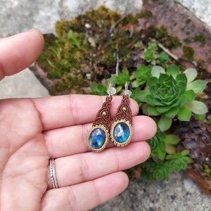 May include: A pair of brown and gold macrame earrings with blue labradorite gemstone drops.