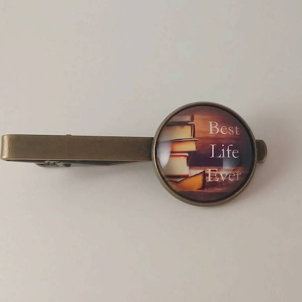 JW Men's Tie Bar featuring "Best Life Ever." Stack of books background /Jw menswear/ jw accessories/ jw gifts/ jw items