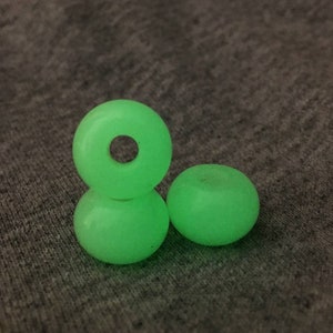May include: Three green glow-in-the-dark skateboard wheels.