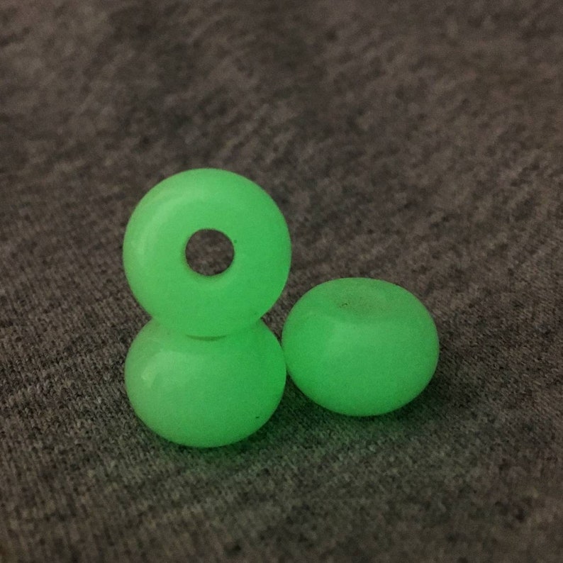May include: Three green glow-in-the-dark skateboard wheels.
