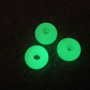 May include: Three glow-in-the-dark green plastic rings with a hole in the center.